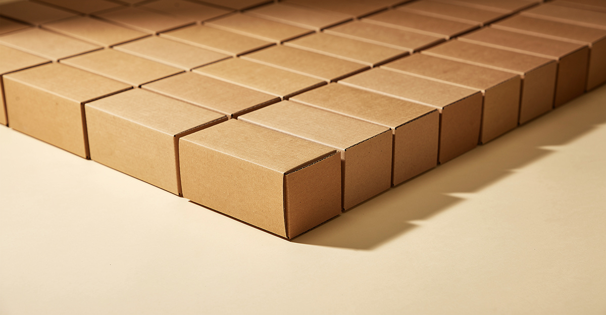 A neat grid of identical kraft boxes with one turned forward, representing a single brand's catalogue inside a larger marketplace